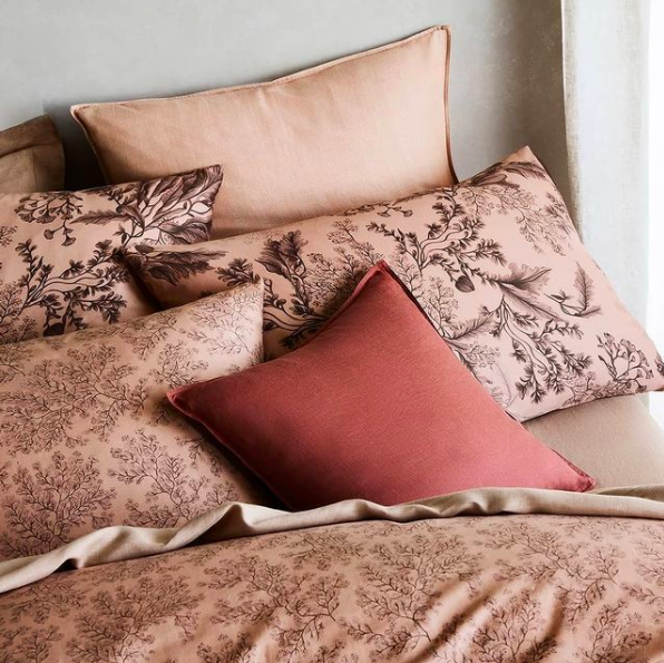 warm toned pillows and cushions on a bed